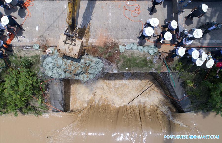Caminhão reboque é utilizado para bloquear passagem de água em região alagada em Changsha