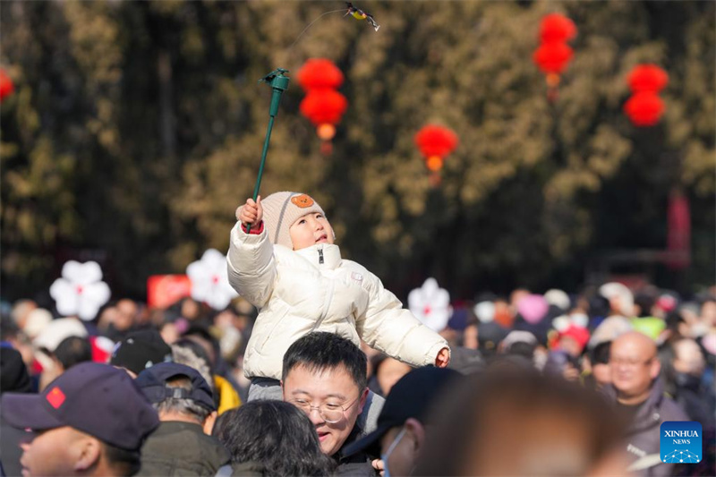 Moradores e turistas visitam a feira do templo da Festa da Primavera no Parque Ditan, em Beijing