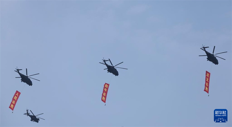 Marcha do desfile militar do Dia da Vitória da China começa com esquadrão de guarda de bandeiras sobrevoando Praça Tian'anmen